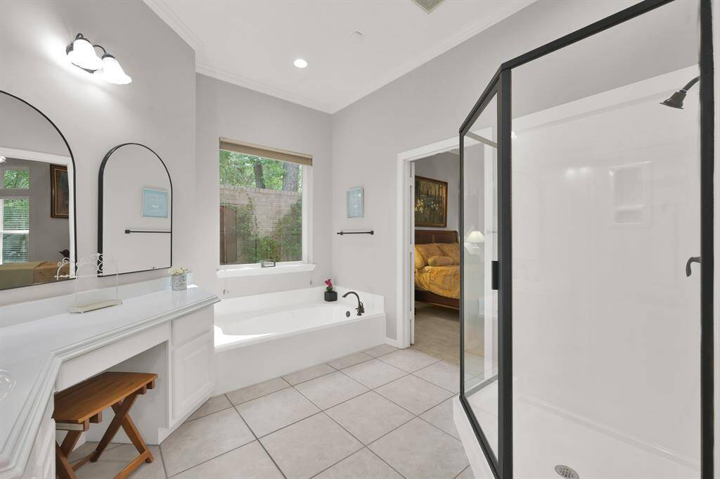 Separate tub with an atrium view and stand alone shower