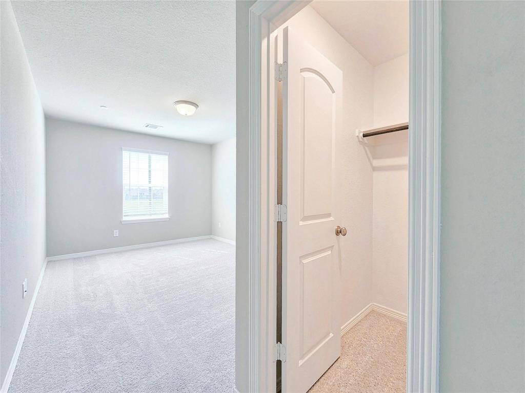 Walk in closet to one of the secondary bedrooms