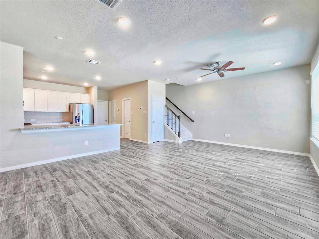 Upon entering you are greeted by wood-like tile floors