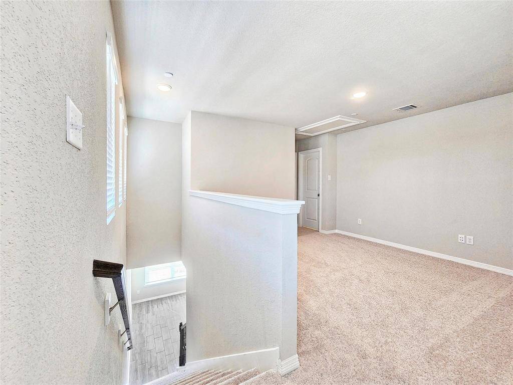 At the top of the stairs is loft space which would make a great TV area, gameroom, or meditation/exercise space