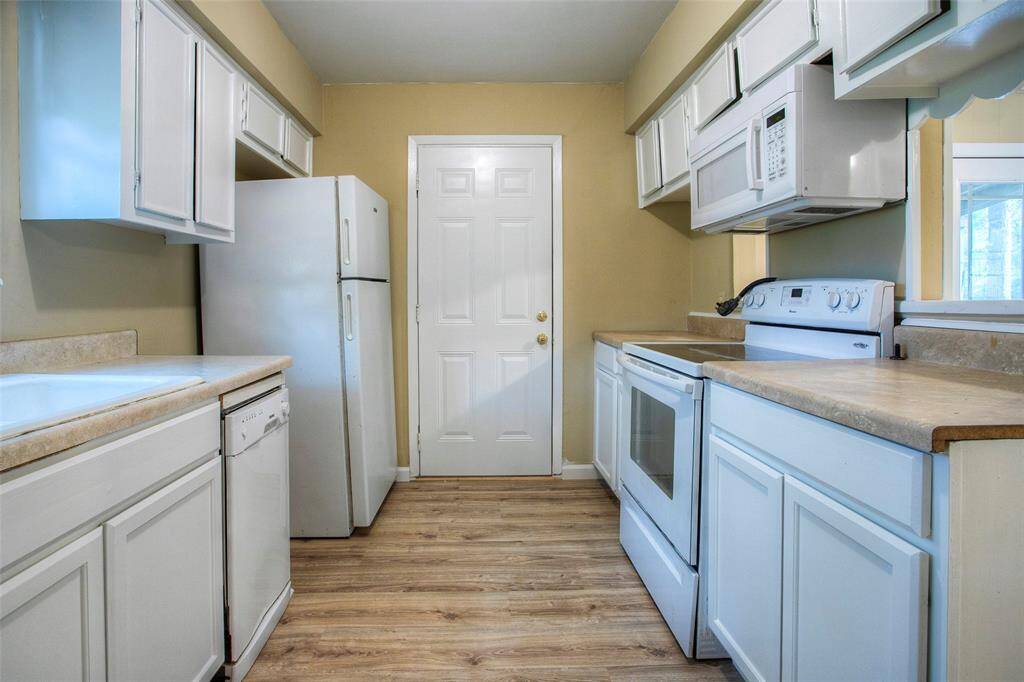 Kitchen facing side exterior door.