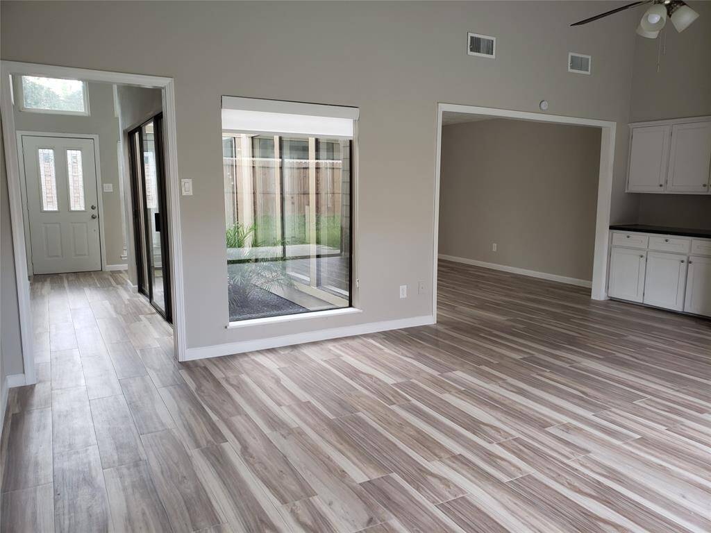 FROM FAMILY ROOM LOOK TO FRONT ENTRANCE, ATRIUM AND FORMAL DINING ROOM