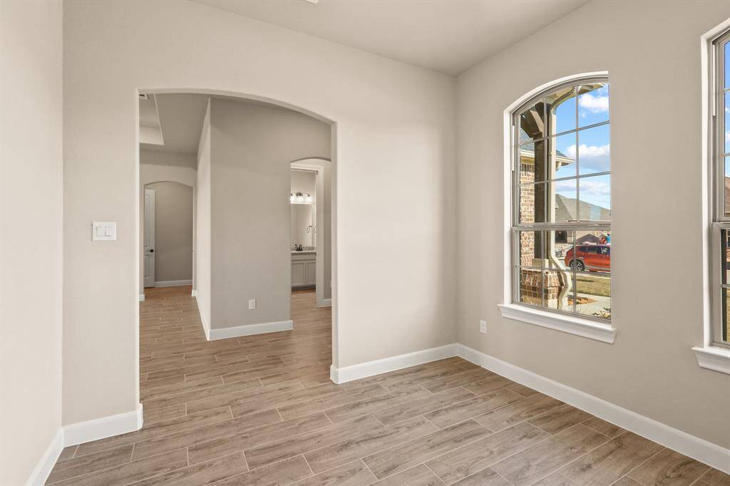 The dedicated home office features large windows that fill the space with natural light, creating a bright and inspiring environment perfect for productivity and focus.