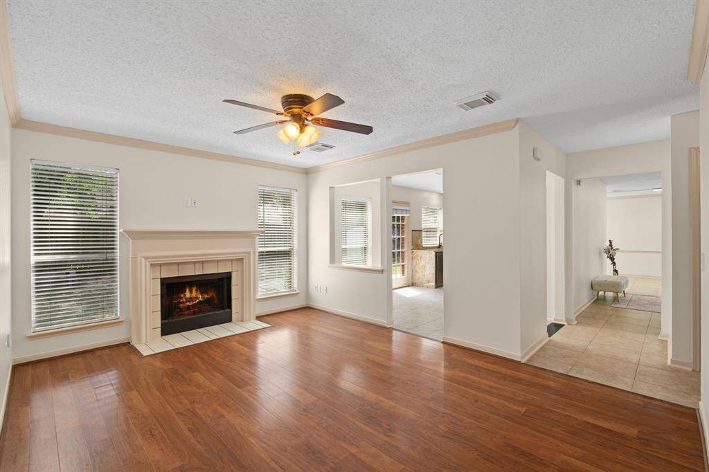 Perfect for relaxing, this family room provides a cozy ambiance with its gas fireplace, privacy from the formal areas, convenient access to the kitchen, and a lovely view of the backyard.