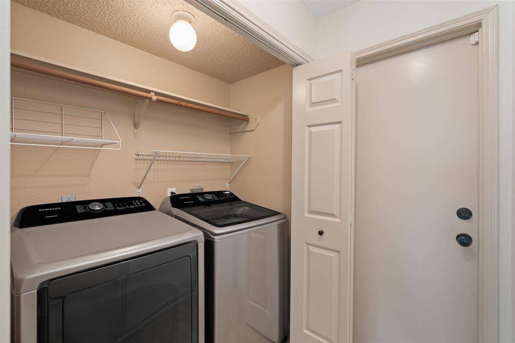 This first-floor utility room offers a discreet and functional space, conveniently located off the hallway by the guest bathroom and garage entry.