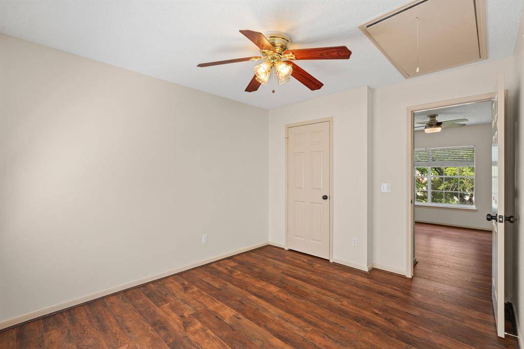 Natural light floods this spacious third bedroom, featuring a large window with serene backyard views. Its seamless connection to the adjacent game room creates an even more expansive and open feel.