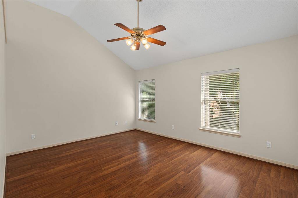 Retreat to this spacious and light-filled primary bedroom, boasting a high ceiling that enhances its airy feel. An elegant archway seamlessly connects to the private bathroom and a large walk-in closet, creating a true owner's oasis.
