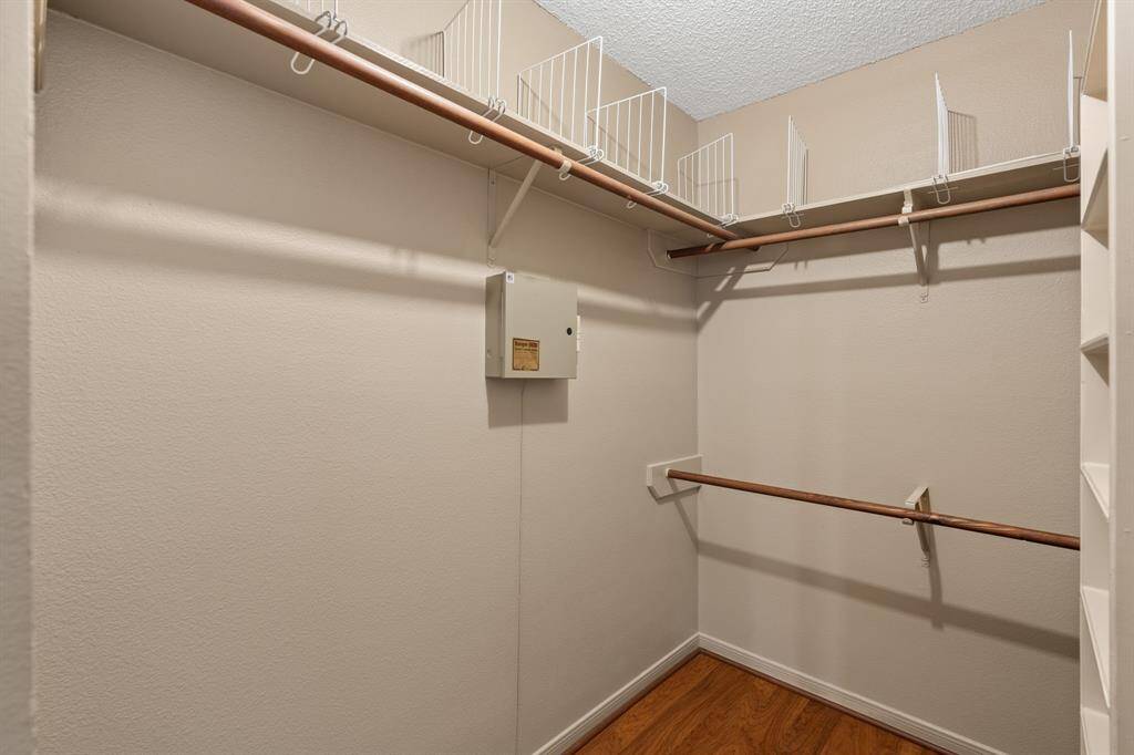 Organized bliss awaits! Discover the expansive potential of this large primary walk-in closet, ready to perfectly house your wardrobe.
