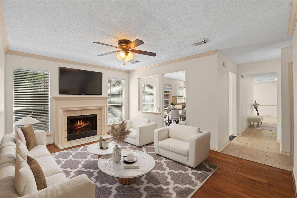 Perfect for relaxing, this family room provides a cozy ambiance with its gas fireplace, privacy from the formal areas, convenient access to the kitchen, and a lovely view of the backyard.