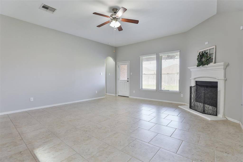 Spacious living area with gaslog fireplace.