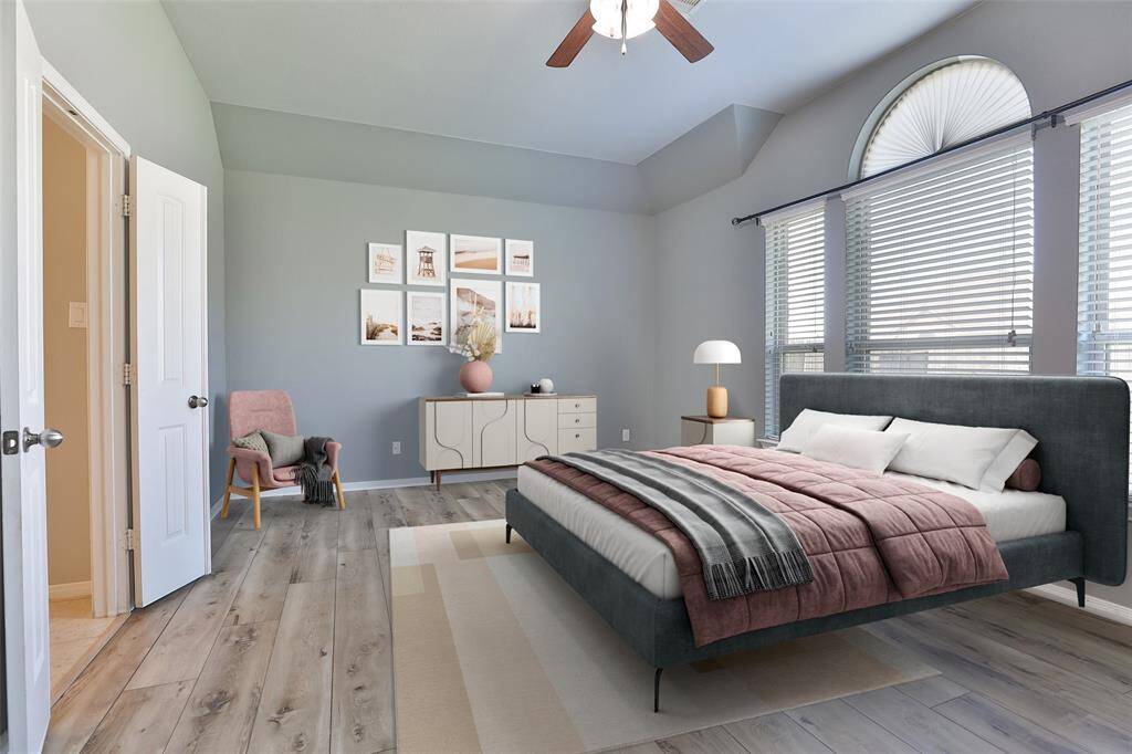 Large primary bedroom with updated lighting and LVP flooring.
