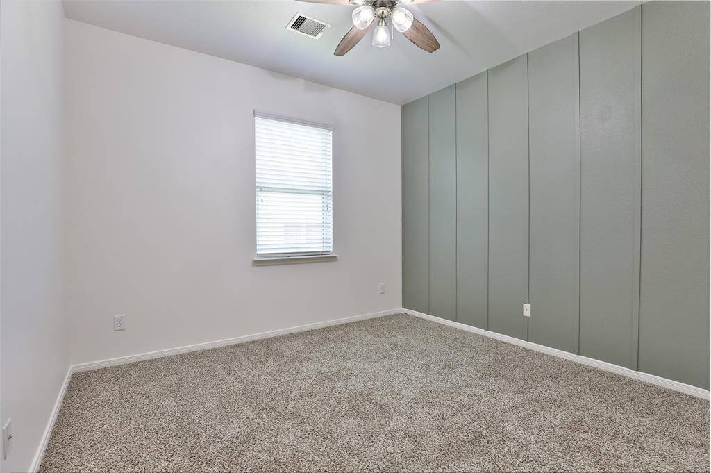 Secondary room 1 with updated board and batten accent wall.