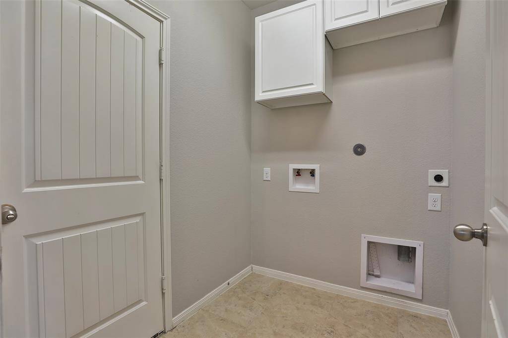 Landry room with cabinet storage and access to gargage.