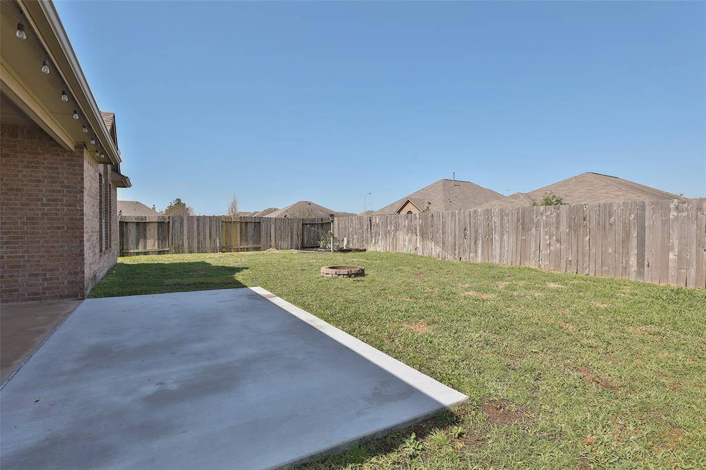 Enjoy grilling or watching the big game on this extended patio with fixed TV.