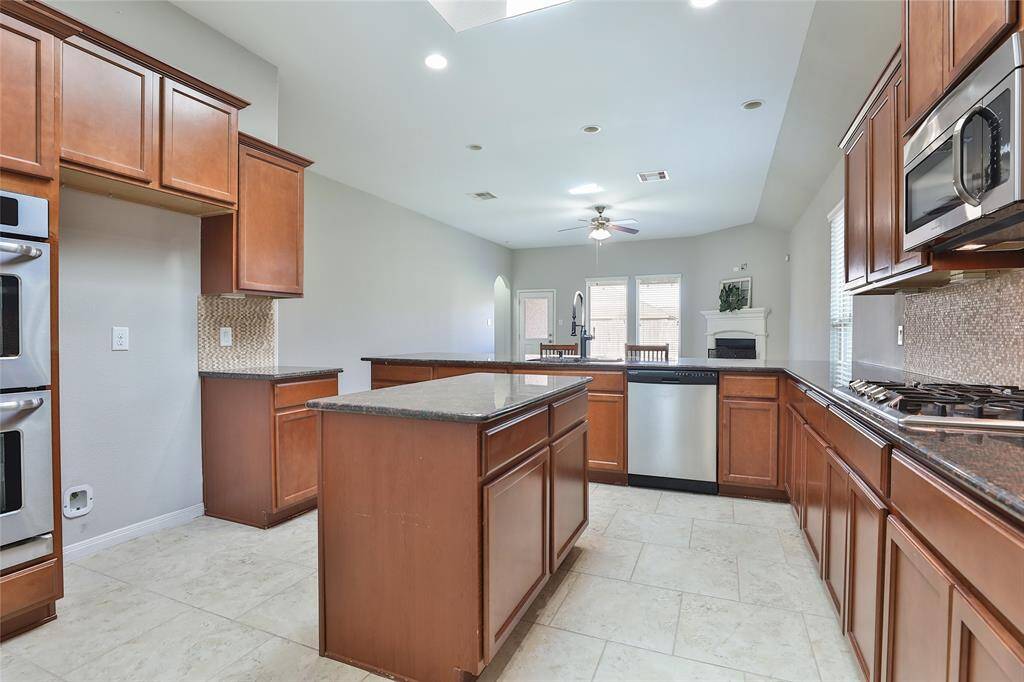 Open kitchen with plenty of natural light, ample counter/cabinet space, and large breakfast bar.