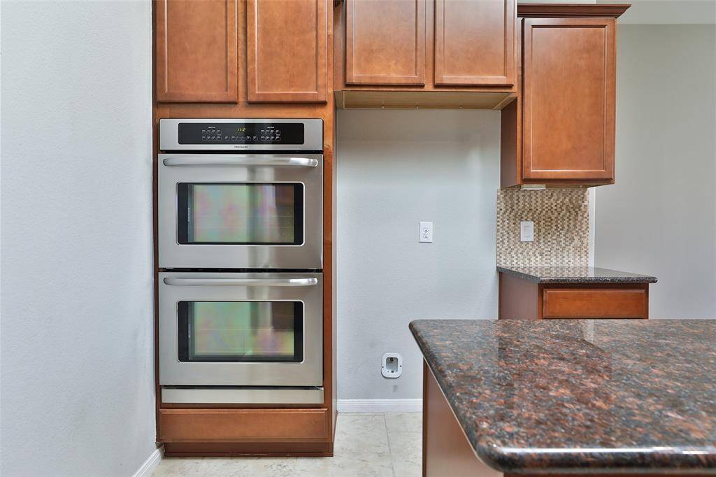 Kitchen offers stainless gas cooktop, double ovens, and coutersunk sink.