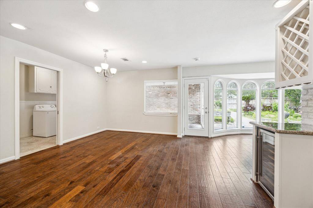 The breakfast area connects seamlessly to the kitchen, utility room, and sunroom. Access door opens to the air-conditioned breezeway, which leads to the backyard and two-car garage.