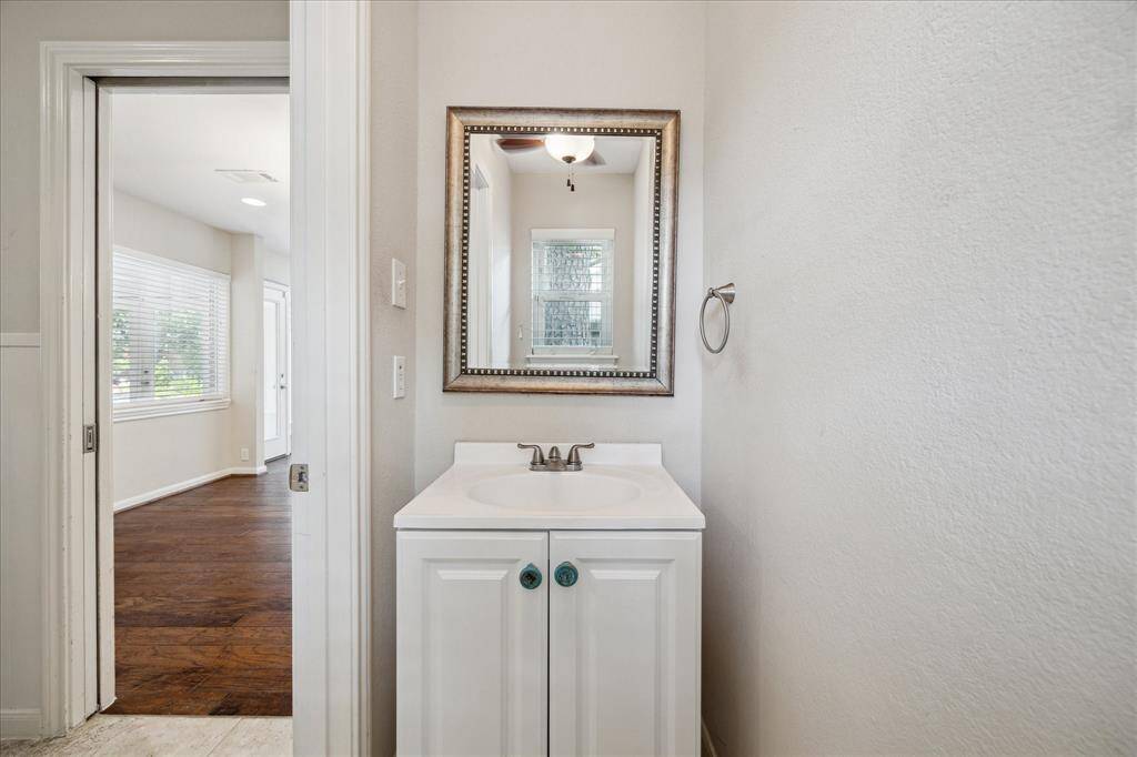 First-floor half bath located just off the utility room.