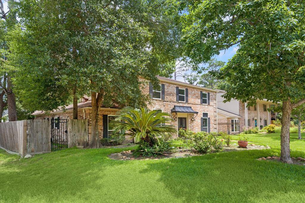 Set on a spacious corner lot, this two-story traditional offers timeless curb appeal and a gated driveway leading to a two-car garage