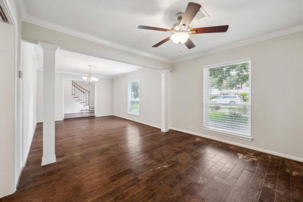 A bright, open flow from the entry through the formal living and dining rooms, with hand-scraped hardwoods, large windows, and timeless details offering a strong foundation for updates.