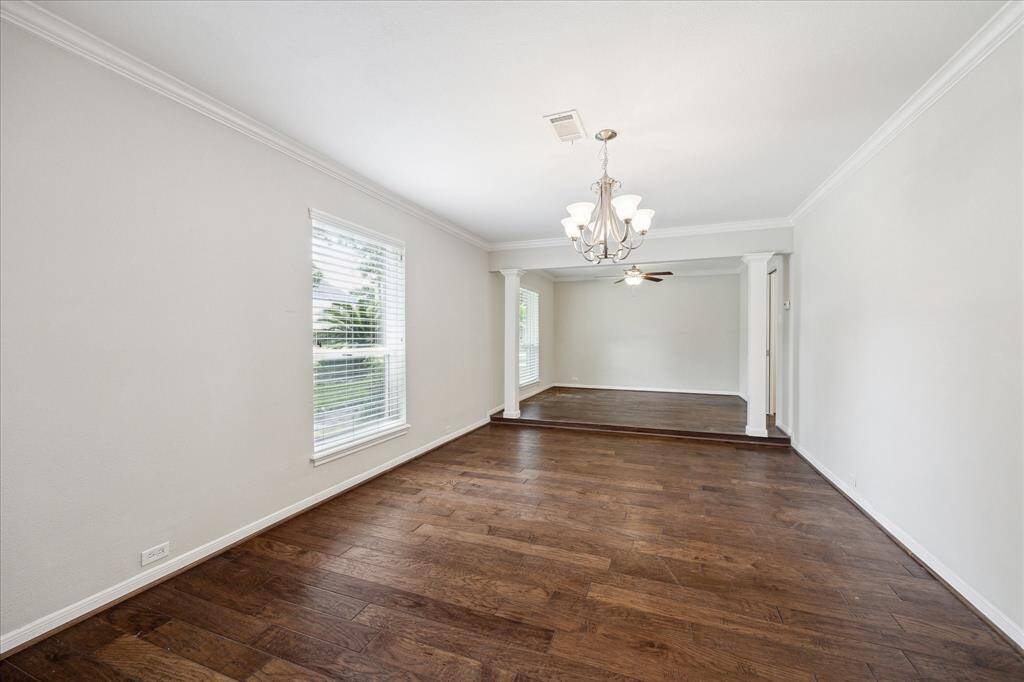 Located off the entry, the formal living and dining rooms feature hand-scraped hardwood floors, crown molding, and abundant natural light. Perfect for gatherings and everyday living.