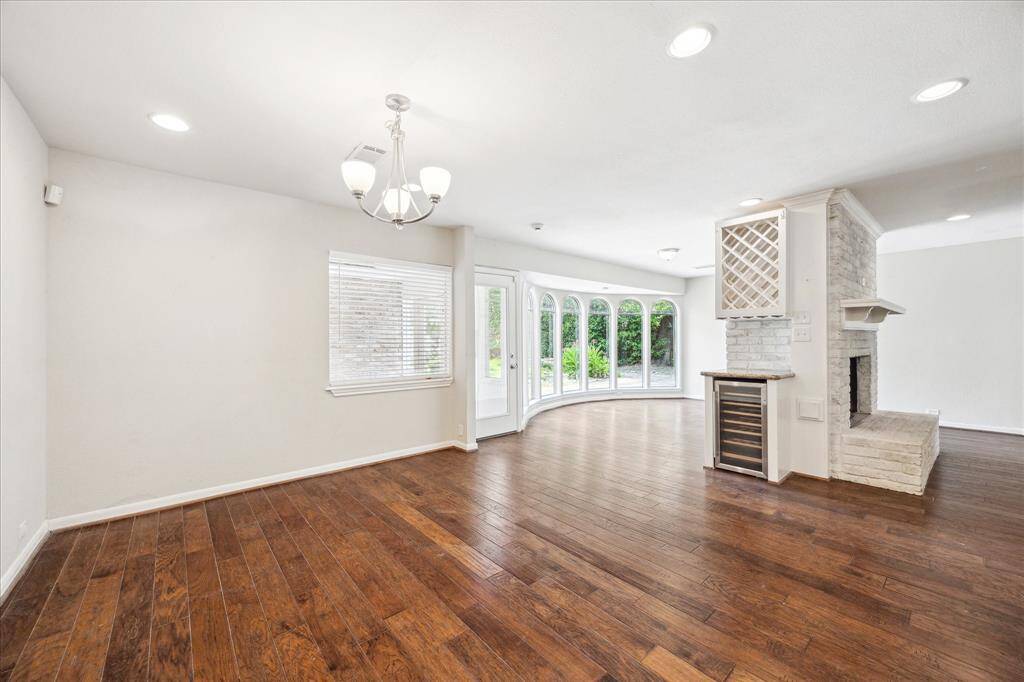 The breakfast room adjoins the kitchen and sunroom, with a built-in wine rack and beverage fridge nearby—ready for casual meals or weekend hosting.