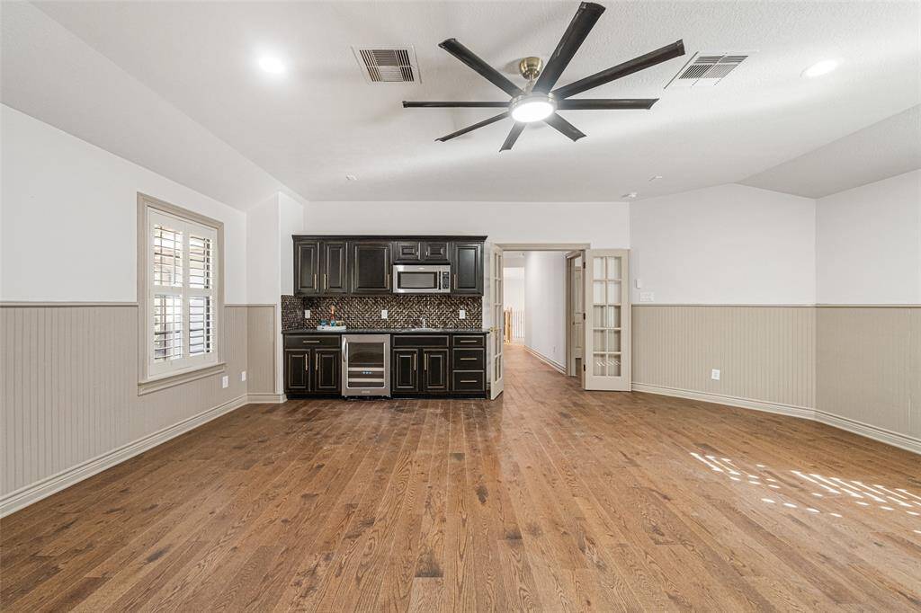 GAMEROOM/MEDIA New 8 blade fan with integrated light is being installled. Great Refreshment Bar with beverage cooler, sink, microwave, granite counters & and cabinets to store snacks. It is great to have a 2nd living space.