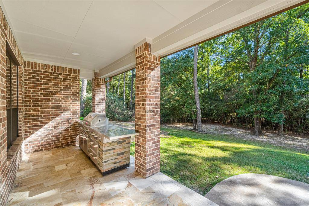 Freshly tiled to coordinated with the new Kitchen Aid Outdoor Grill with counters to complete this great Outdoor Kitchen on the Covered Patio.