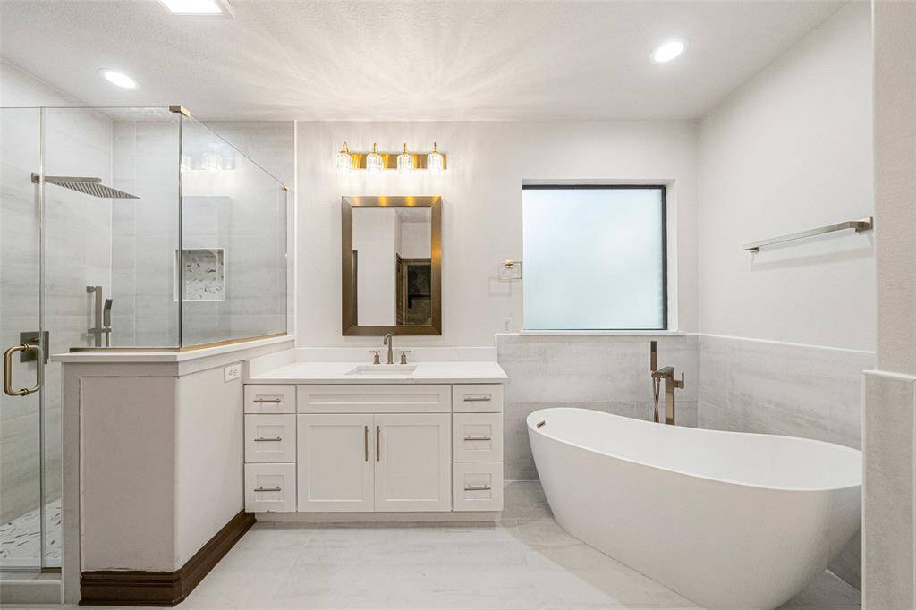 PRIMARY BATH Amazingly gorgeous RENOVATION complete: Quartz "Calcatta Oslina Golld" New frameless shower with beautiful marble tiled surround, quartz countertops, stand-alone deep soaker tub, brushed gold lighting, faucets & mirrors.