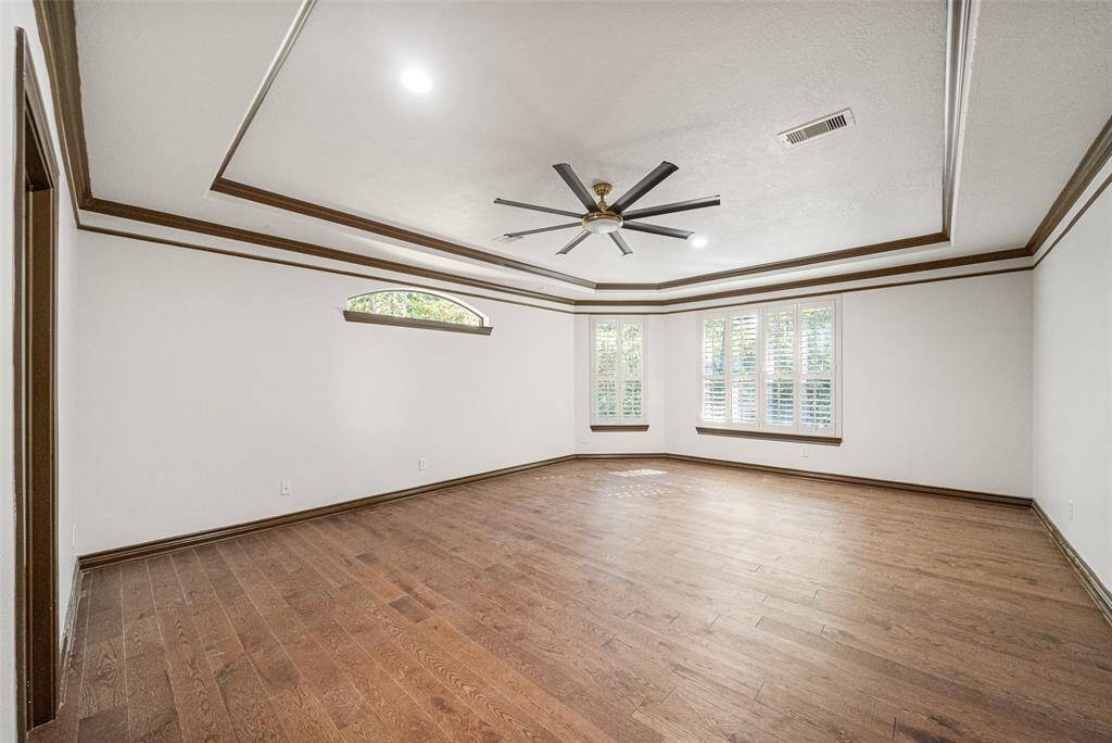 PRIMARY SUITE   Generous size with new integrated light ceiling fan, hardwood floors, tray ceiling & plantation shutters.