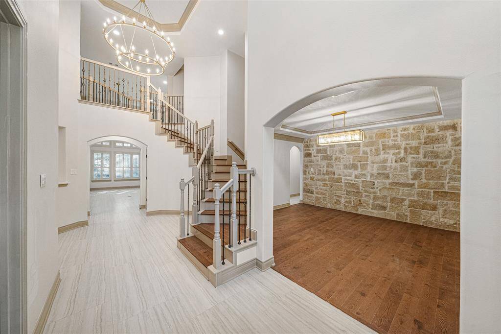STAIRCASE  Photo does not portray the spacious feel of this welcoming entry.