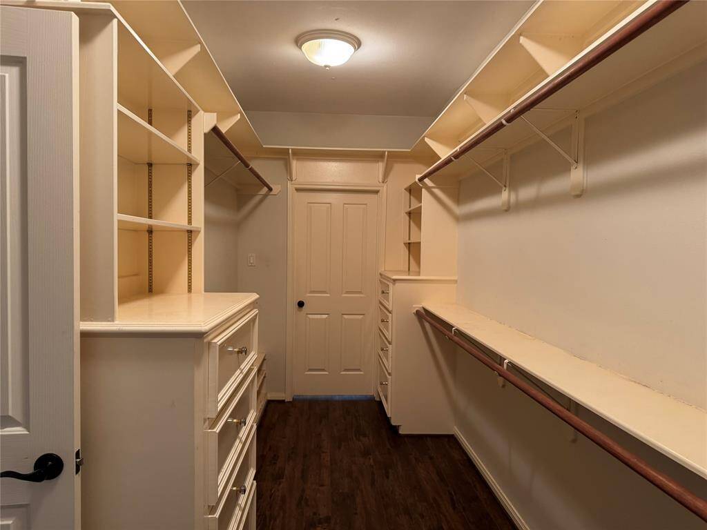 Walk-in closet in the Primary Bedroom. Also has access to the Laundry Room
