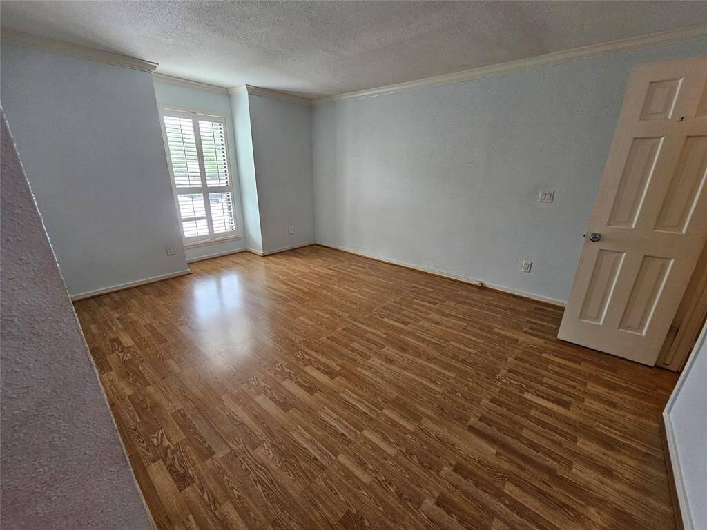 First bedroom with laminate flooring