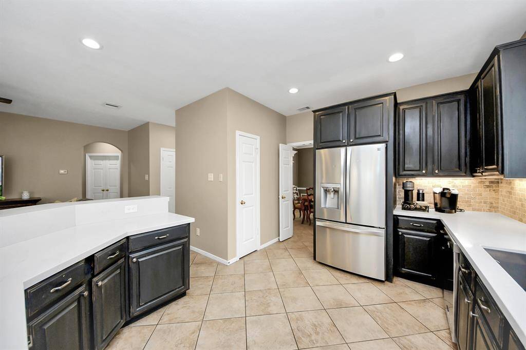 The open-concept layout seamlessly connects the kitchen to the living room, creating an ideal space for entertaining and everyday living.