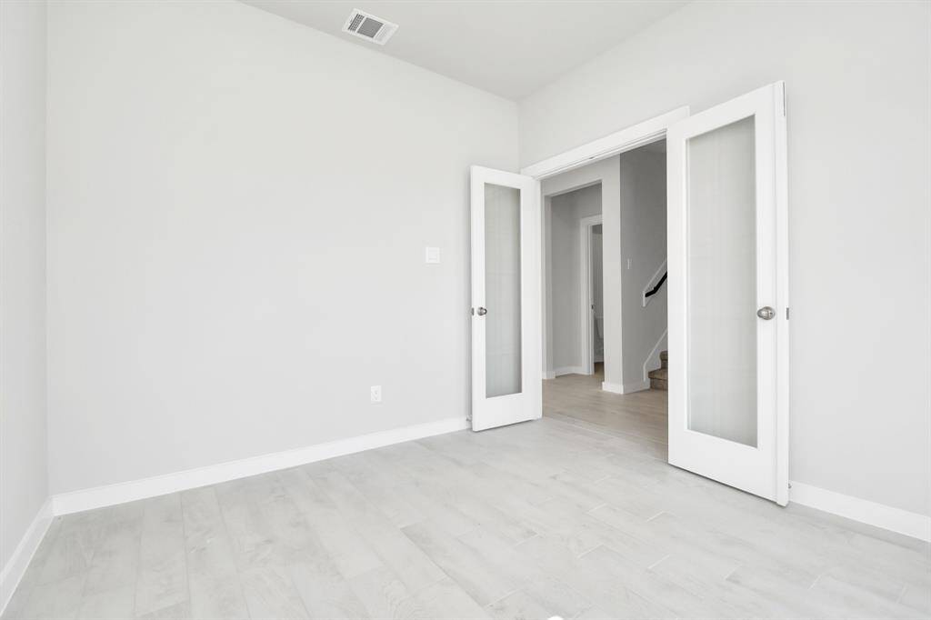 Quietly nestled in front of the home is the sophisticated home office. Featuring plush carpet, custom paint and large windows with privacy blinds. Sample photo of completed home with similar floor plan. Actual colors and selections may vary.