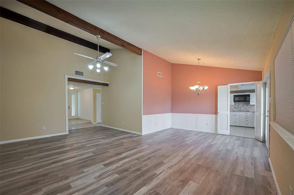 Beams in the Den. This view to the Dining Room and the Kitchen through double doors.