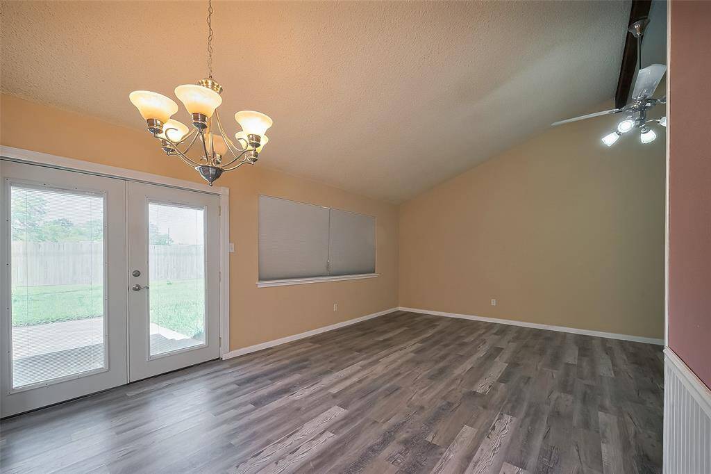 Formal Dining opens to the Den. French Doors lead to back yard.