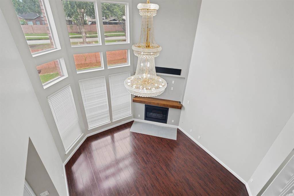 View of Living Room from above. Lots of natural light with the high ceiling and windows.