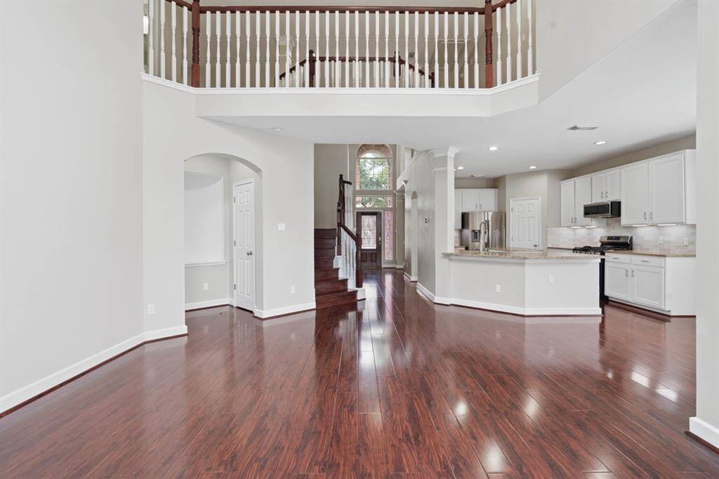 Looking towards the Front door from the Living Room w/high cielings
