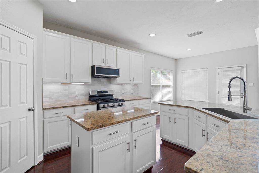 Walk into this Open Style Kitchen w/Granite Countertops and an Island