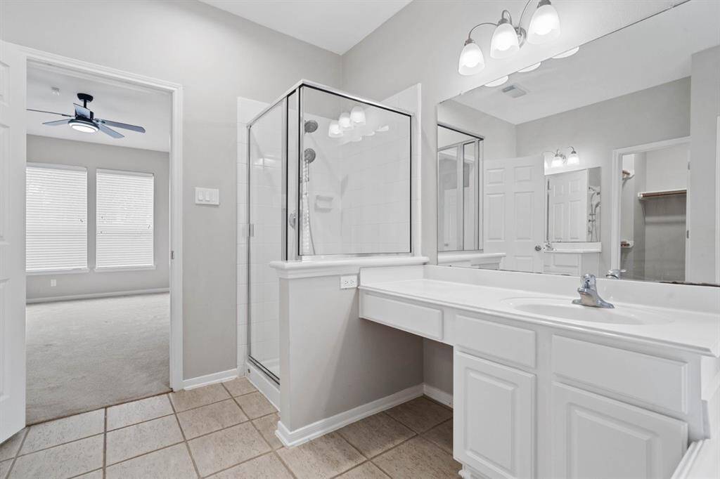 Two sinks with their own counters, drawers and cabinets.