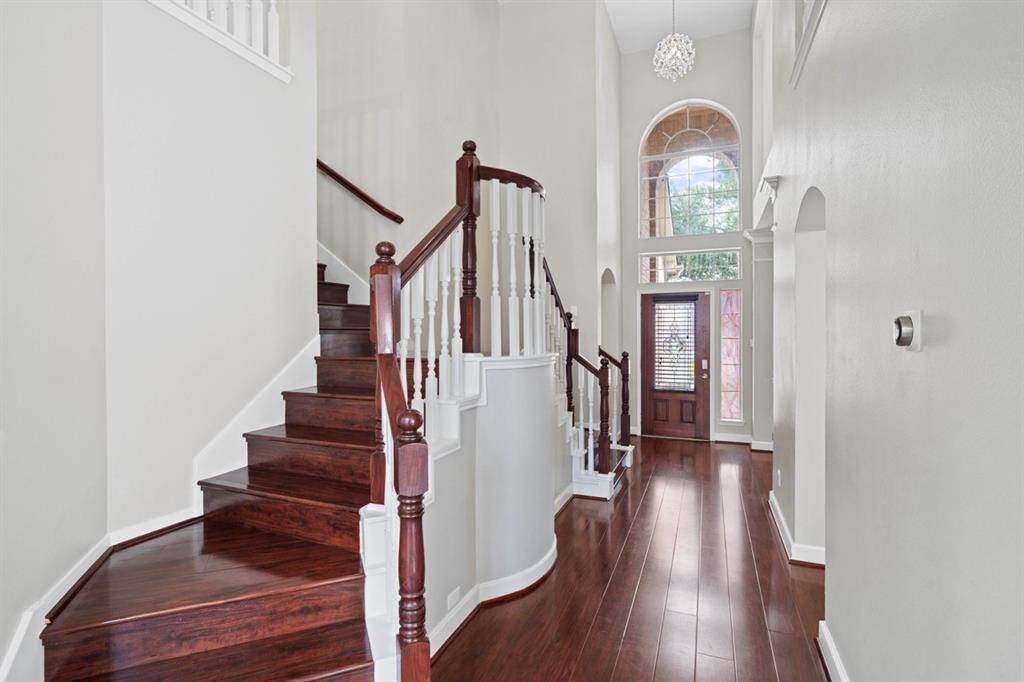 Looking towards the Front door from the Living Room w/high cielings