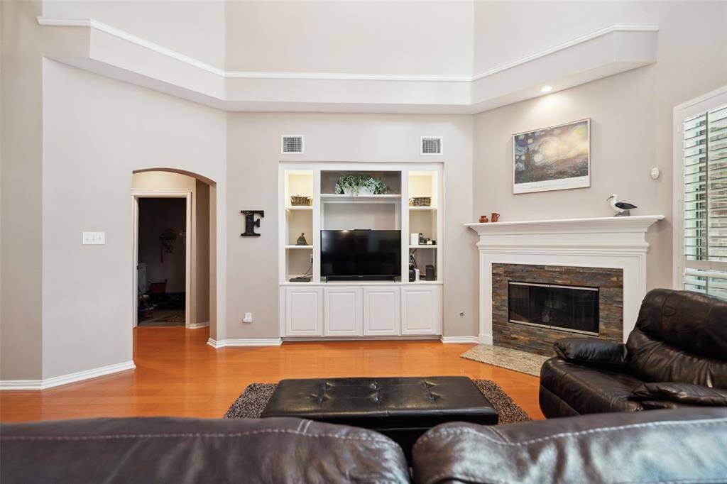 On the opposite side of the home, through the hall, you will find the half bath for guests, the primary en suite, laundry and garage entrance.