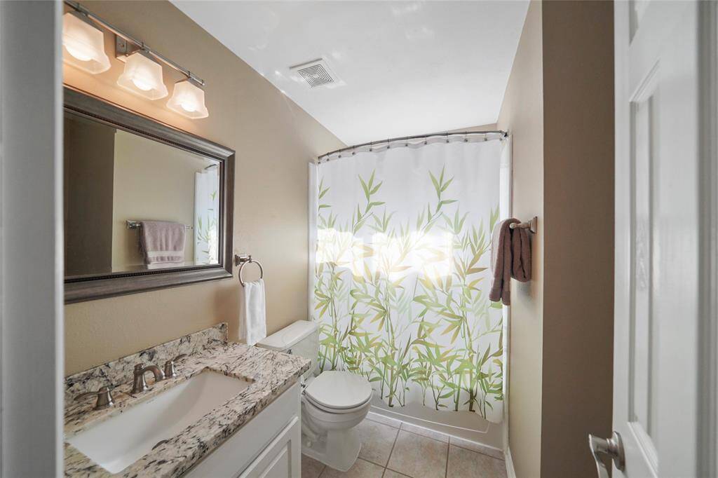 One of the two second floor bathrooms. Beautiful granite countertop, framed mirror.