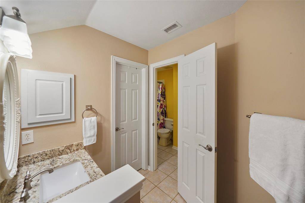Granite countertop, medicine cabinet for extra storage.