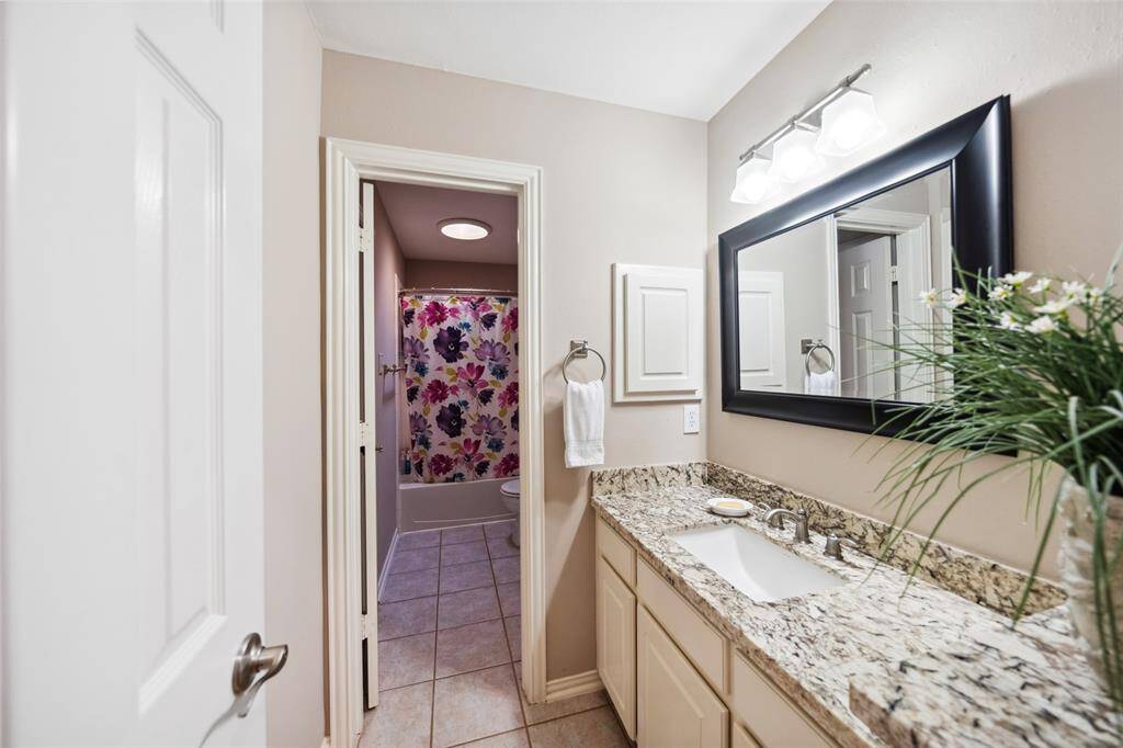 Another sink and vanity with generous storage. Framed mirror.