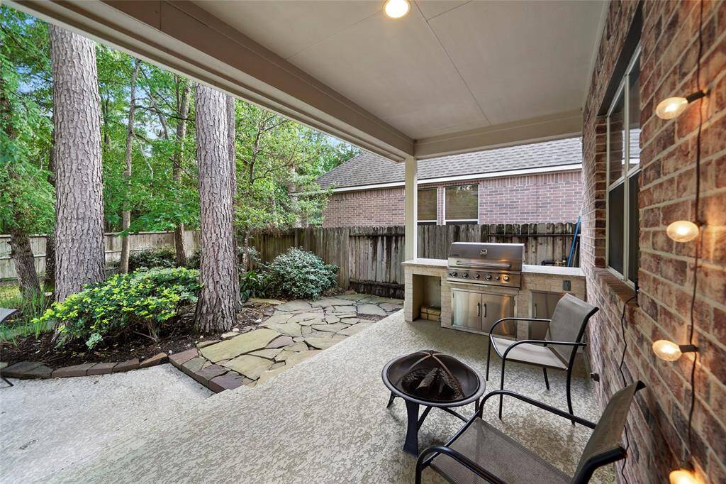 More of the large covered patio showing the built in grill, granite counters and storage.
