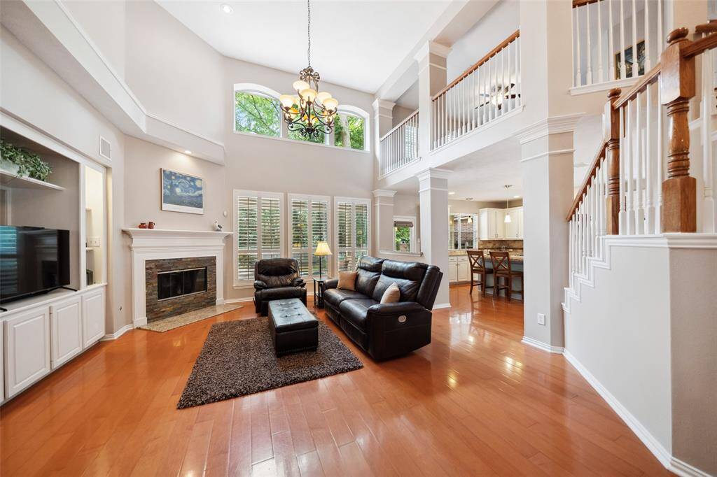 The family room is spacious! Great built in cabinetry with storage and a corner fireplace. Large windows overlook the gorgeous back yard pool!