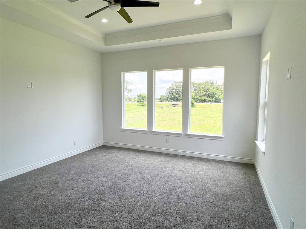 Primary room with a unique tray ceiling design.