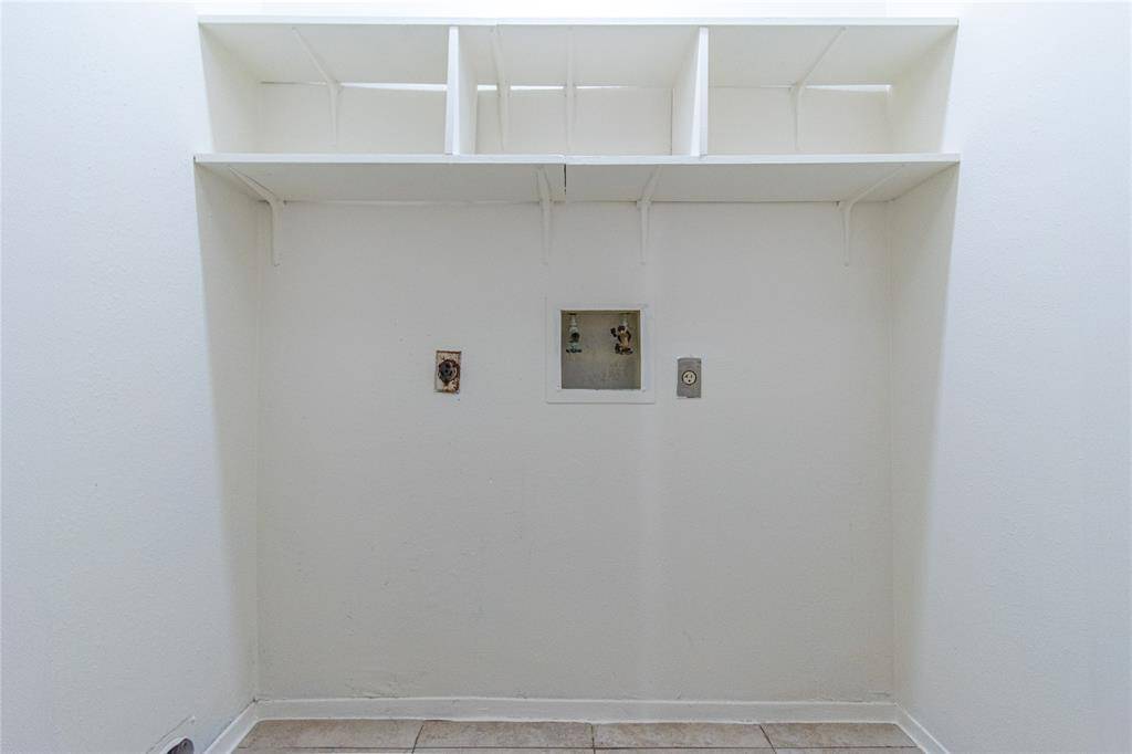 The space has a clean, white finish and tiled flooring.